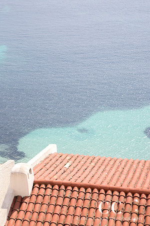 Tile roof and turquoise water, France by Cattie Coyle Photography