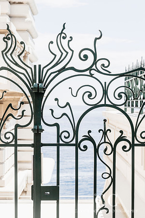 Ornate iron gate with the Mediterranean in the background | Cattie Coyle Photography